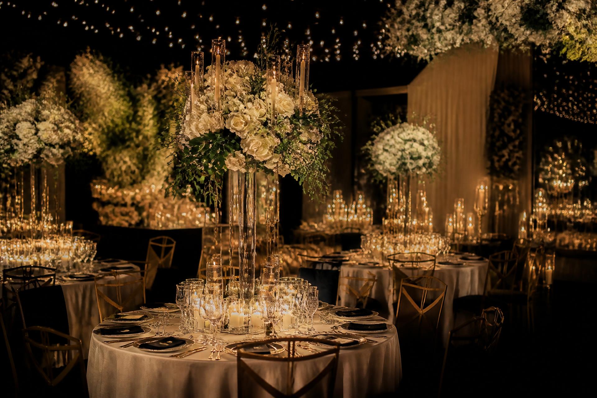 Decoração de casamento sofisticada com velas douradas e flores brancas
